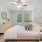 Furnished apartment bedroom with large windows inside homes at Stono Oaks