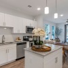 Modern white cabinetry and stainless steel appliances in apartments at Stono Oaks