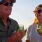 older couple have wine on the lake